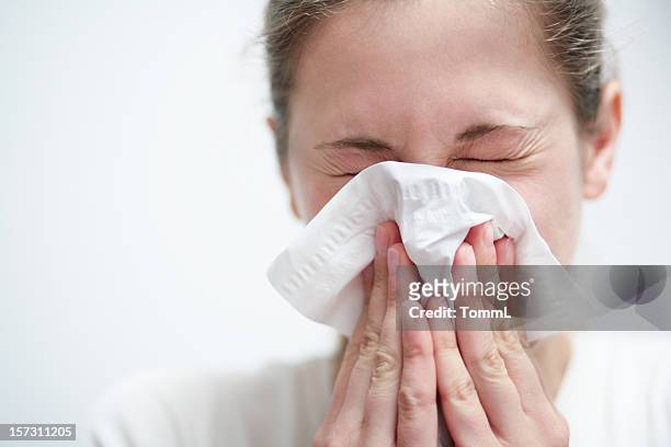 blowing nose - blowing nose stock pictures, royalty-free photos & images