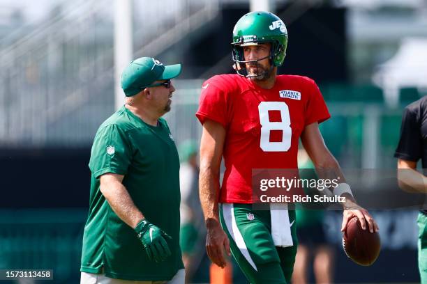 Quarterback Aaron Rodgers of the New York Jets talks with a coach during training camp at Atlantic Health Jets Training Center on July 26, 2023 in...