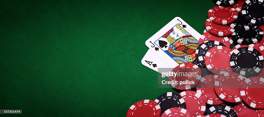 Blackjack table and pile of chips on right side of image