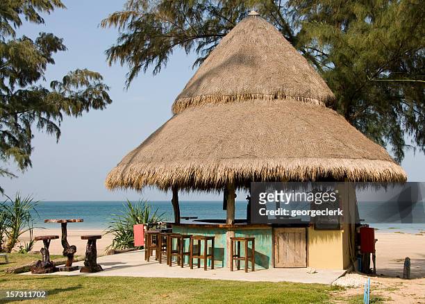tropical beach bar - thatched roof huts stock pictures, royalty-free photos & images