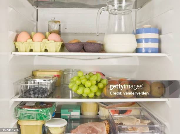 three fridge shelves full of food - inside refrigerator stock pictures, royalty-free photos & images