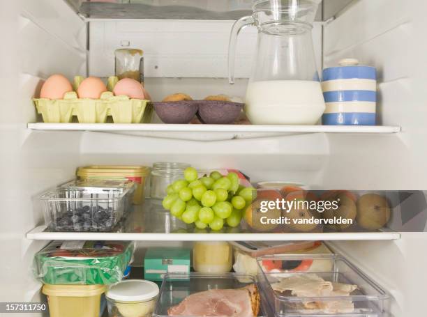 three fridge shelves full of food - inside of fridge stock pictures, royalty-free photos & images