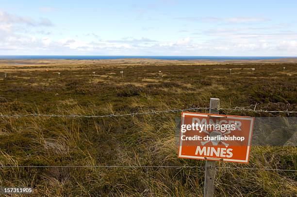 danger minefield with warning sign - land mine stock pictures, royalty-free photos & images