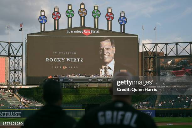 Manager Pedro Grifol of the Chicago White Sox watches the scoreboard during a moment of silence tribute to Rocky Wirtz of the Chicago Blackhawks at...