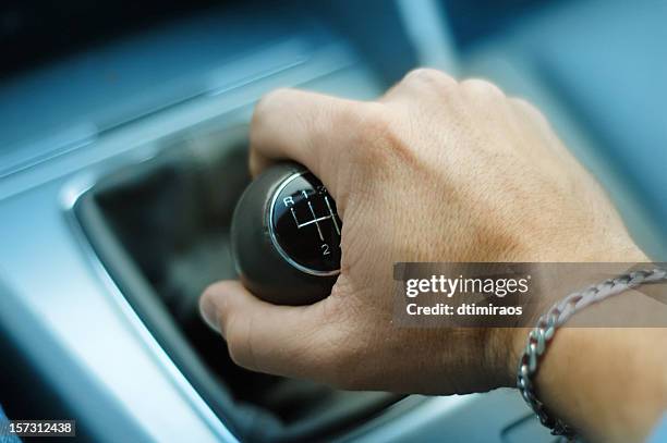 hand downshifting car five speed manual transmission - shift gear knob stock pictures, royalty-free photos & images