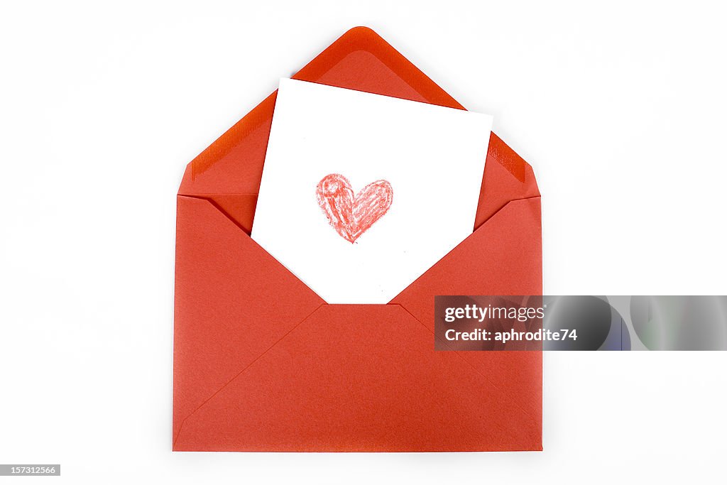 Red heart drawn on white card within red envelope