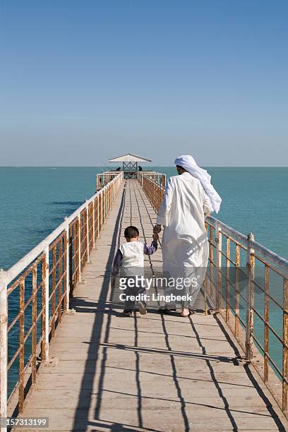 arab father and son - kuwaiti stock pictures, royalty-free photos & images