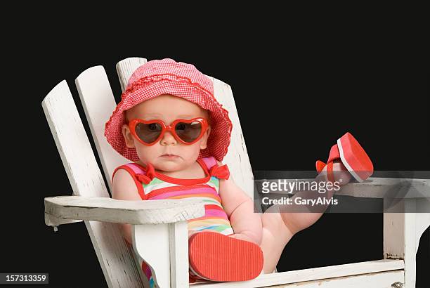 toddler girl in adirondack chair w/leg up,sunglasses on-total relaxation - adirondack chair closeup stock pictures, royalty-free photos & images