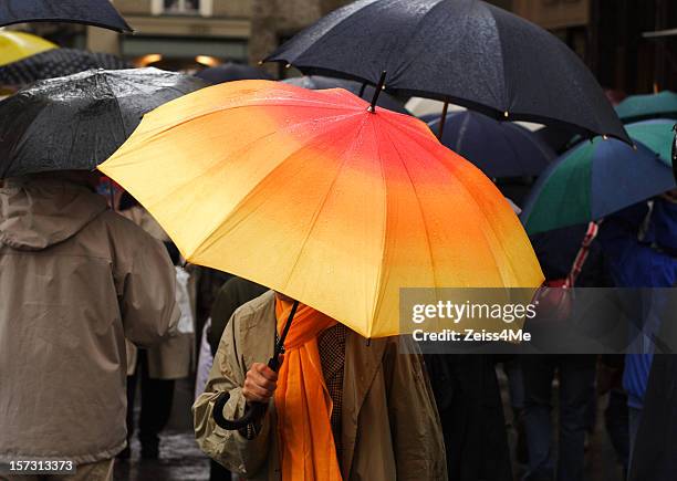 colorful umbrellas in the rain - differentiation stock pictures, royalty-free photos & images