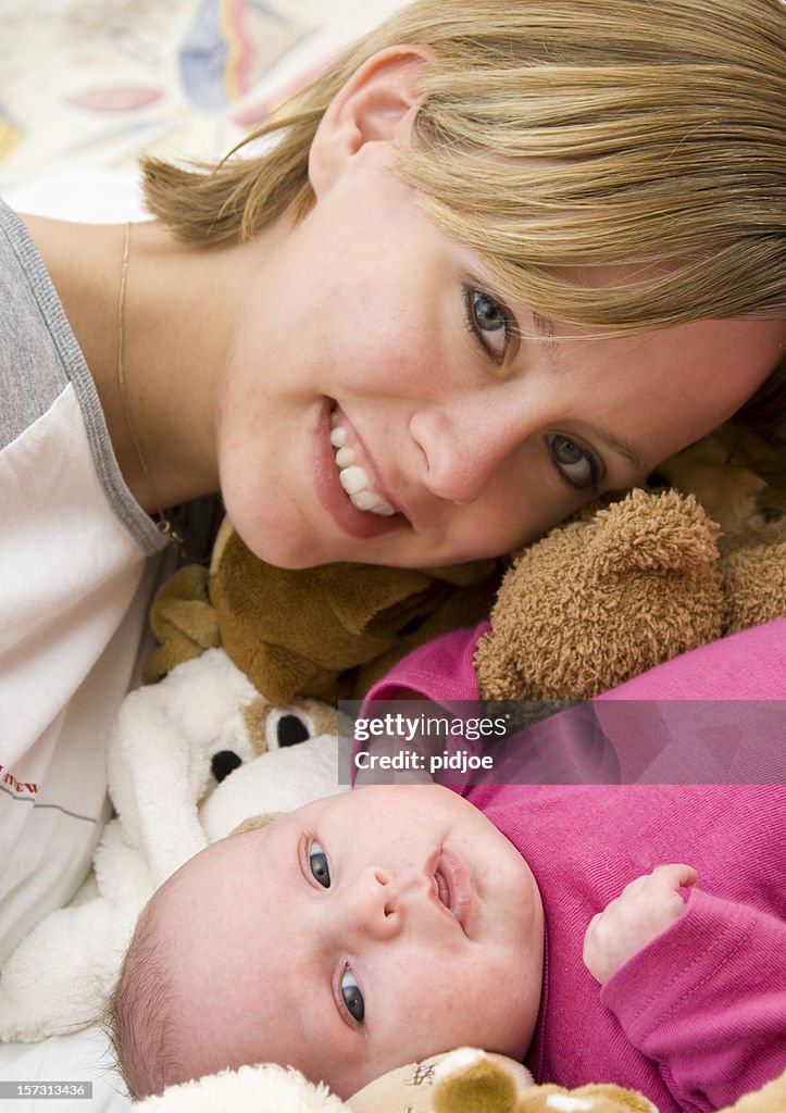 Smiling proud mother and her baby