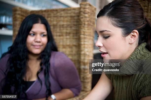 asian indian and caucasian friends talking in coffee shop - 20s talking serious bildbanksfoton och bilder