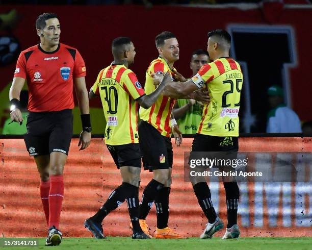 Danilo Santacruz of Pereira celebrates with teammates after scoring the team's first goal during the Copa CONMEBOL Libertadores round of 16 match...