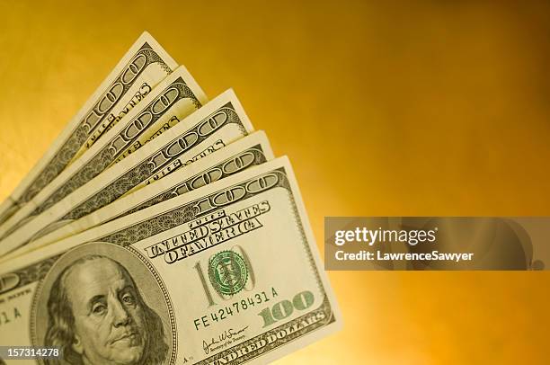 five american one hundred dollar bills isolated on yellow - us paper currency stockfoto's en -beelden