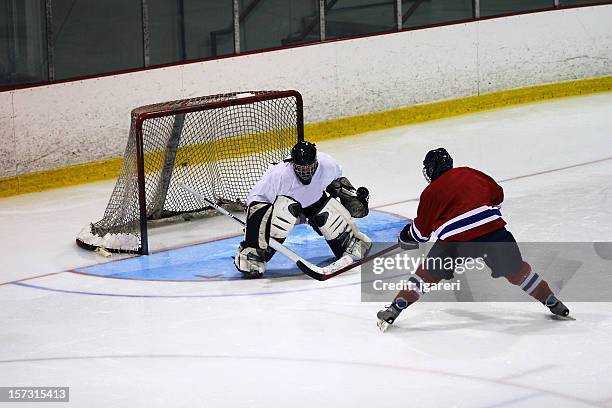 hockey goaltender action shot - hockey puck in net stock pictures, royalty-free photos & images