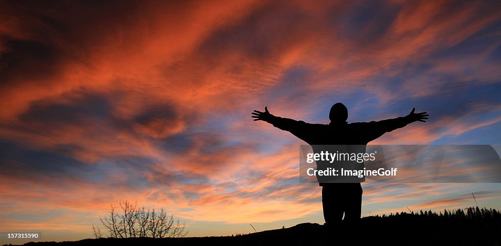 Unrecognizable Man With Arms Outstretched in Worship
