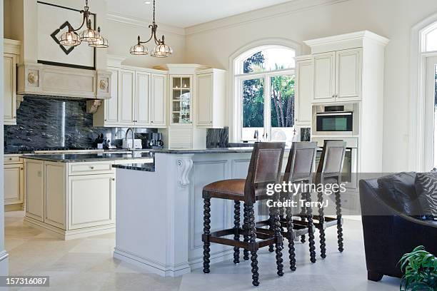 beautiful custom kitchen with breakfast bar in estate home - beauty cabinet stock pictures, royalty-free photos & images