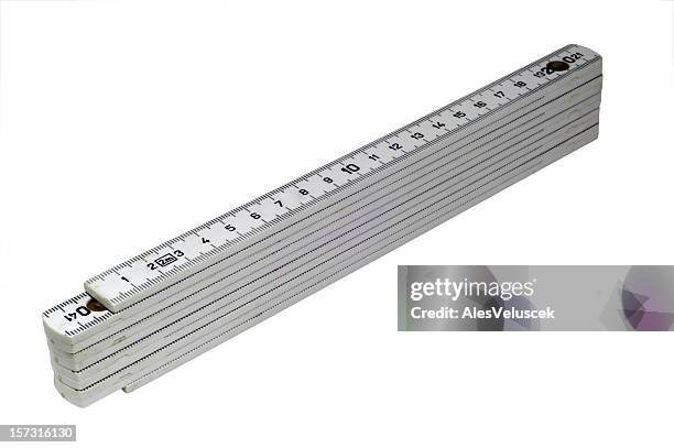 a silver folding ruler on a white background - measuring stick stock pictures, royalty-free photos & images