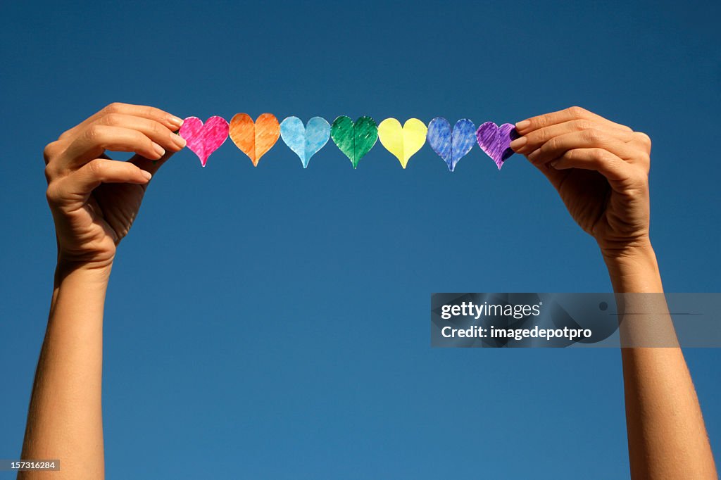 Woman holding colorful hearts
