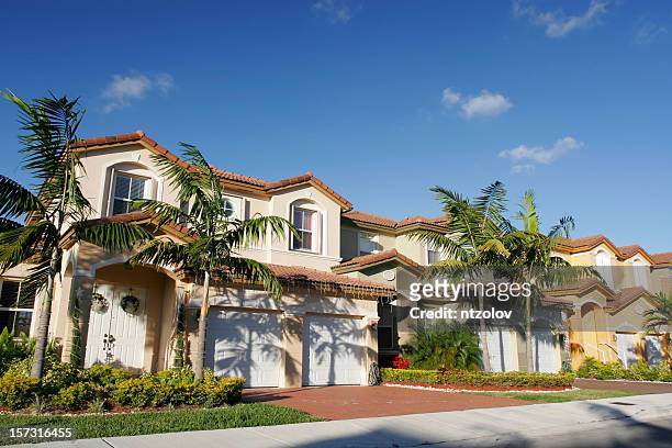 a beautiful house for a single family with palm trees - blue house red door stock pictures, royalty-free photos & images