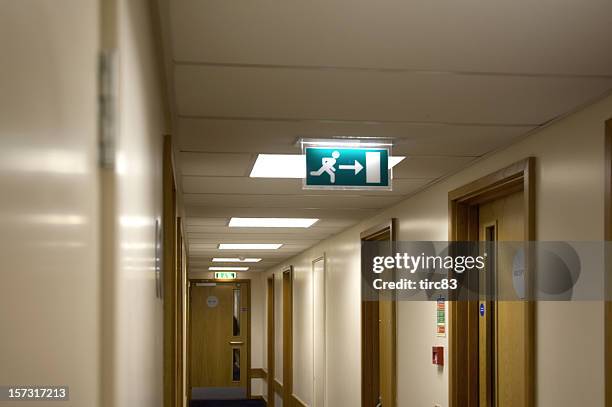 hotel corridor fire exit - emergency exit stock pictures, royalty-free photos & images