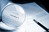 Magnifying Glass Examining Signed Legal Contract