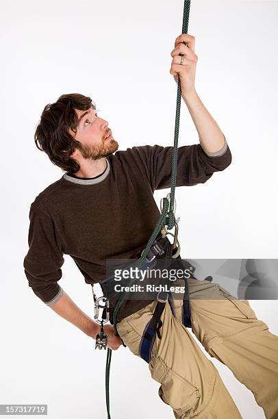 young man rappelling - human finger stock pictures, royalty-free photos & images