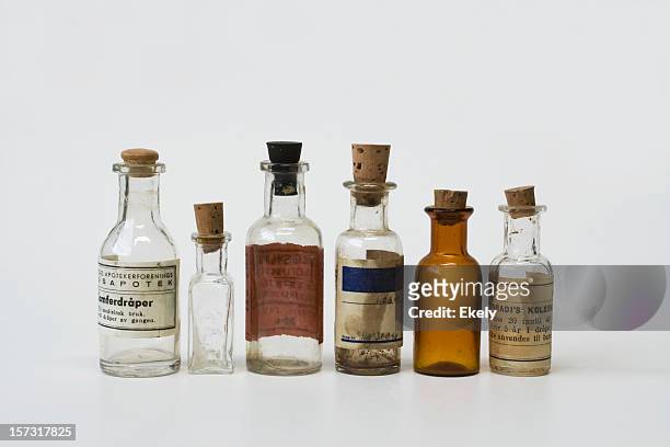 group of small vintage translucent medicine bottles. - toxin stockfoto's en -beelden