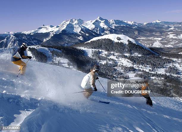 three friends skiing fresh powder - family skiing stock pictures, royalty-free photos & images