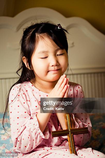 night praying to jesus christ - holy cross girls stock pictures, royalty-free photos & images