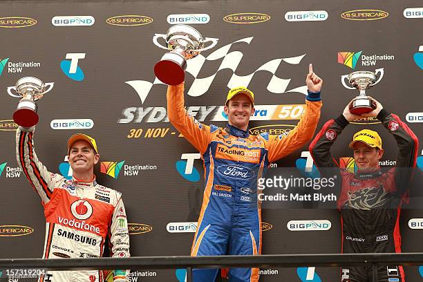 Second place Craig Lowndes driver of the Team Vodafone Holden, first place Will Davison driver of the Tradingpost FPR Ford and third place James...