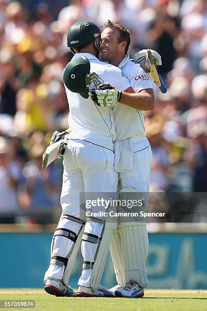 De Villiers of South Africa celebrates scoring a century with team mate Faf Du Plessis during day three of the Third Test Match between Australia and...