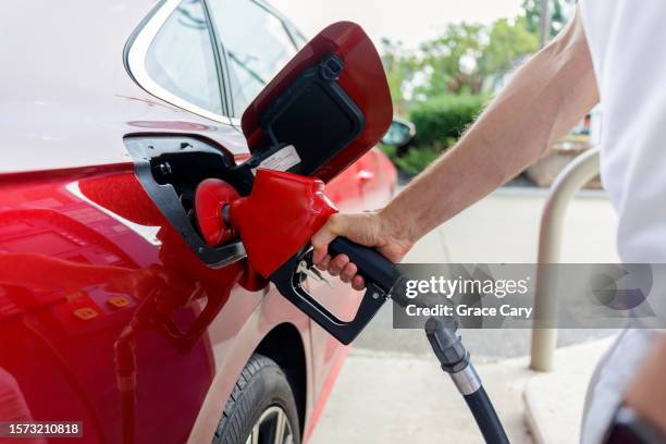 man refuels his car at gas station - fuel pump stock pictures, royalty-free photos & images