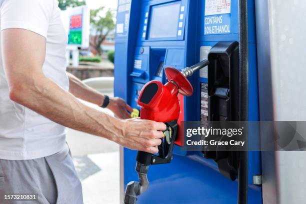 man prepares to refuel his car at gas station - high stock pictures, royalty-free photos & images
