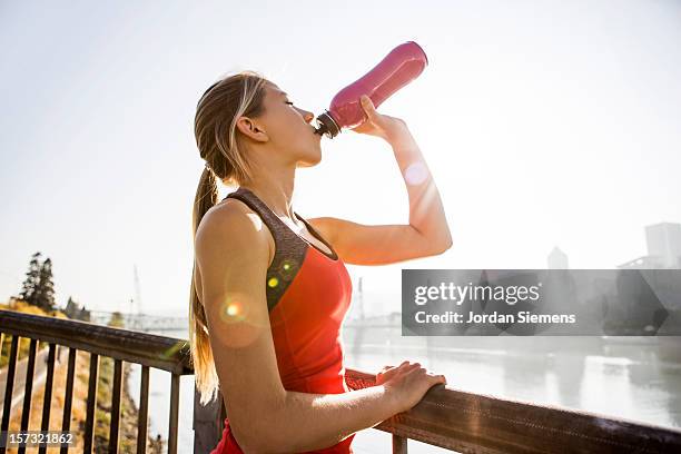 a female drinking water. - bottle water sport foto e immagini stock