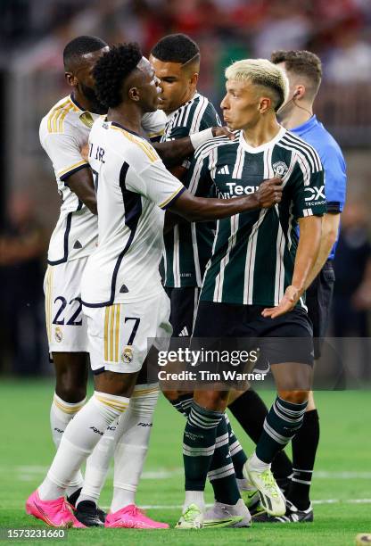 Vinicius Júnior of Real Madrid and Lisandro Martinez of Manchester United react in the first half during the 2023 Soccer Champions Tour match at NRG...