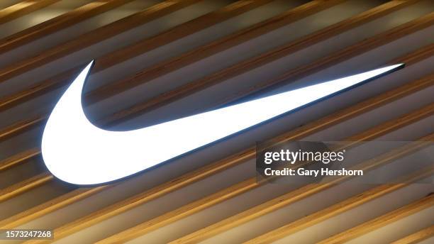 An Nike corporate logo hangs on a wall outside their store at the Eaton Center shopping mall on July 26 in Toronto, Canada.
