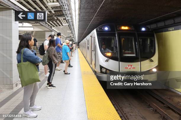 Subway train arrives at the Finch Station as people wait on a platform to board on July 26 in Toronto, Canada.