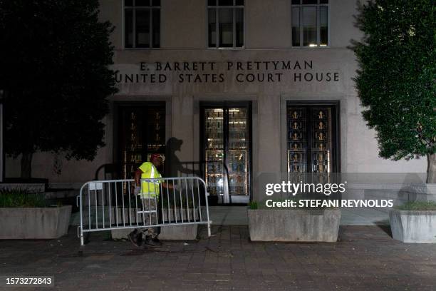 Workers set up security barricades outside the E. Barrett Prettyman US Courthouse in Washington, DC, on August 2 ahead of the arraignment of former...