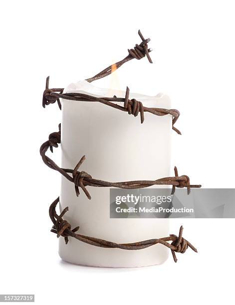 candle with barbed wire - surrounding stock pictures, royalty-free photos & images