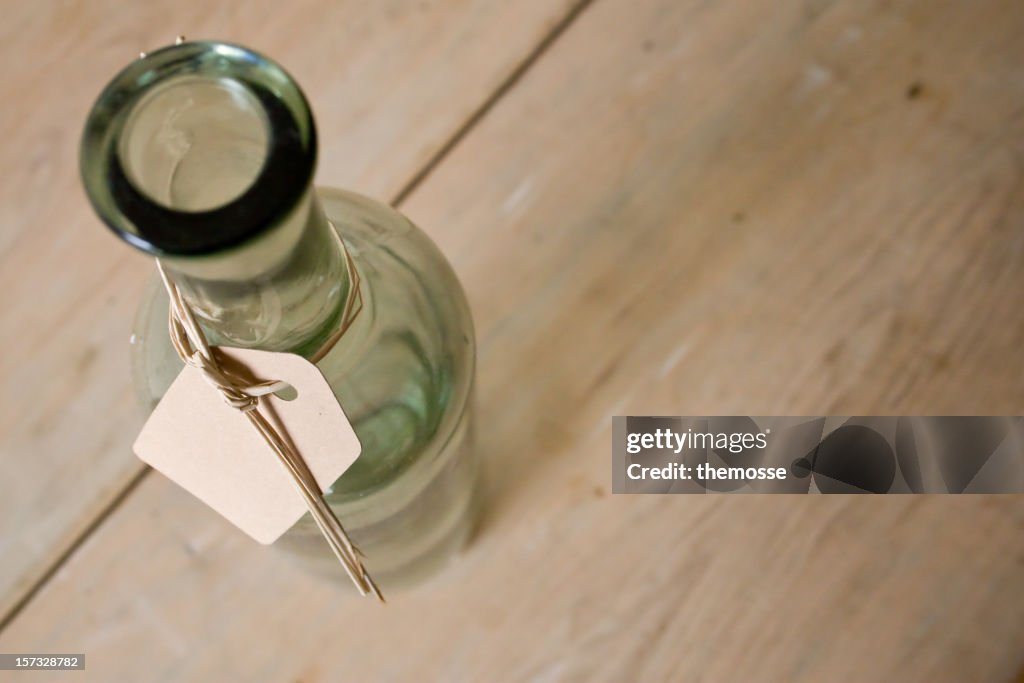 Glass bottle with message tag