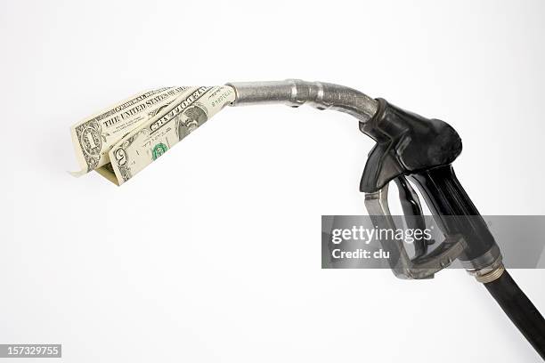 pump nozzle sucking dollars - fuel price stockfoto's en -beelden