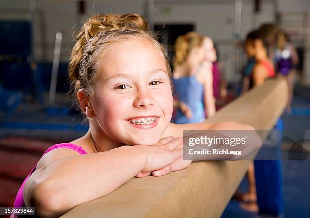 young woman gymnast in a gym - acrobatic stock pictures, royalty-free photos & images