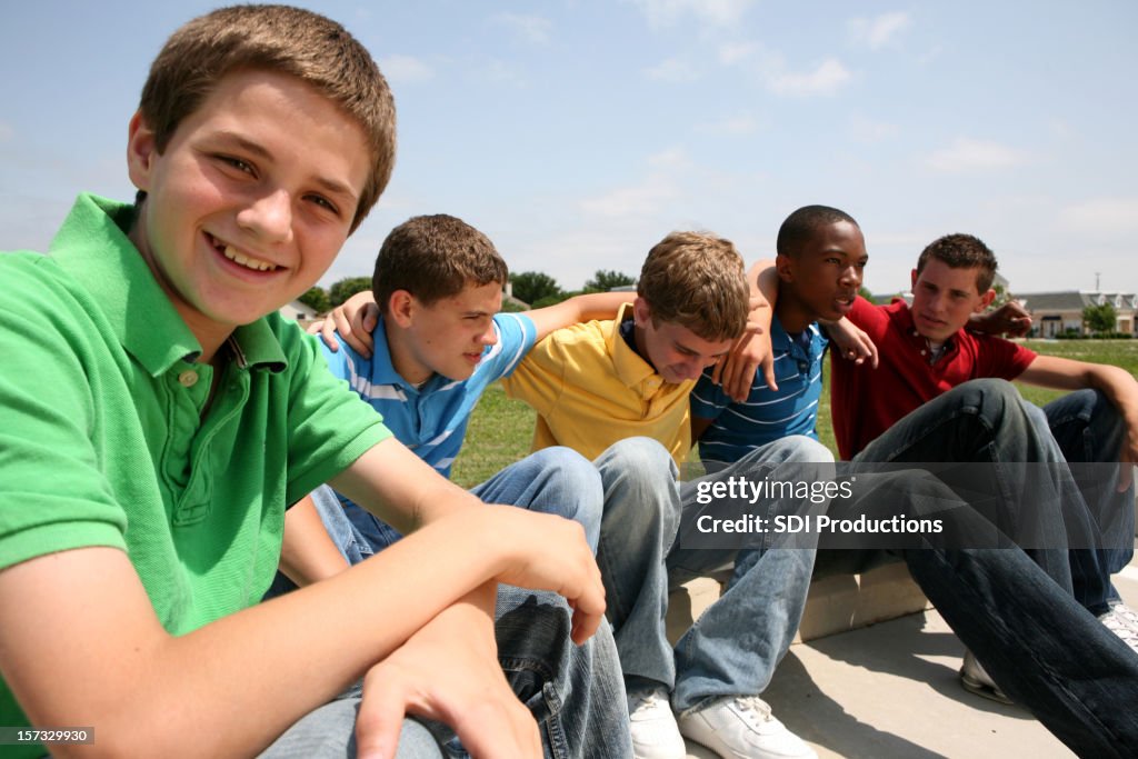 Group of teenage boys sitting in the sun
