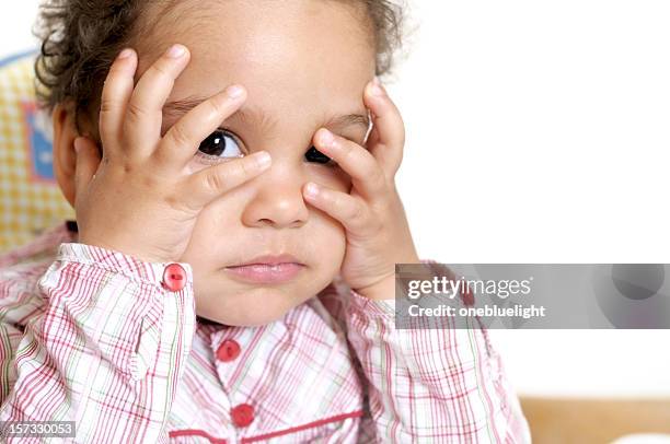 child covering her head with hands against white background - hands covering eyes stock pictures, royalty-free photos & images