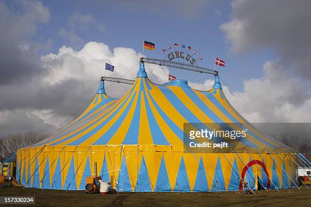 focus on circus tent with dramatic cloudscape background - entertainment tent stock pictures, royalty-free photos & images