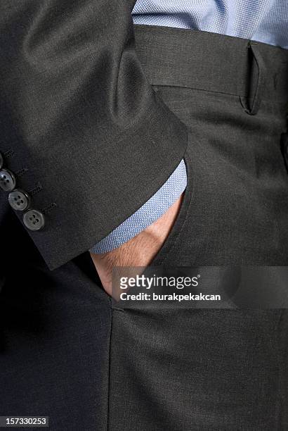 businessman's hand in pocket - grijze broek stockfoto's en -beelden