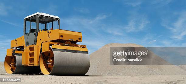 road roller at construction site - wals stockfoto's en -beelden