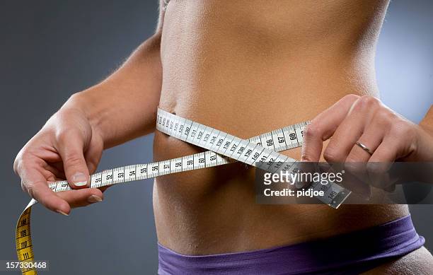 young woman measuring hips - kilogram 個照片及圖片檔