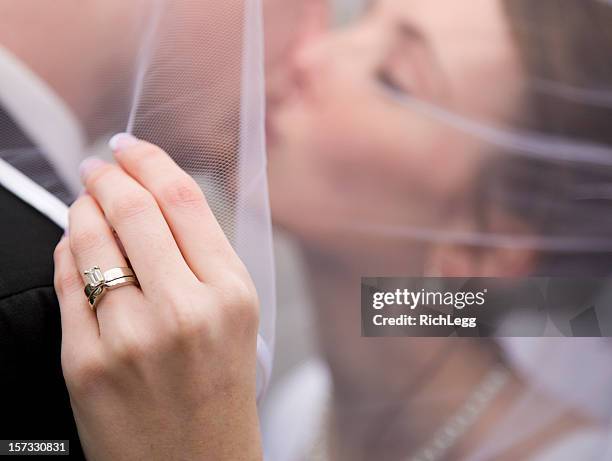 bride and groom under veil - couple jewelry stockfoto's en -beelden