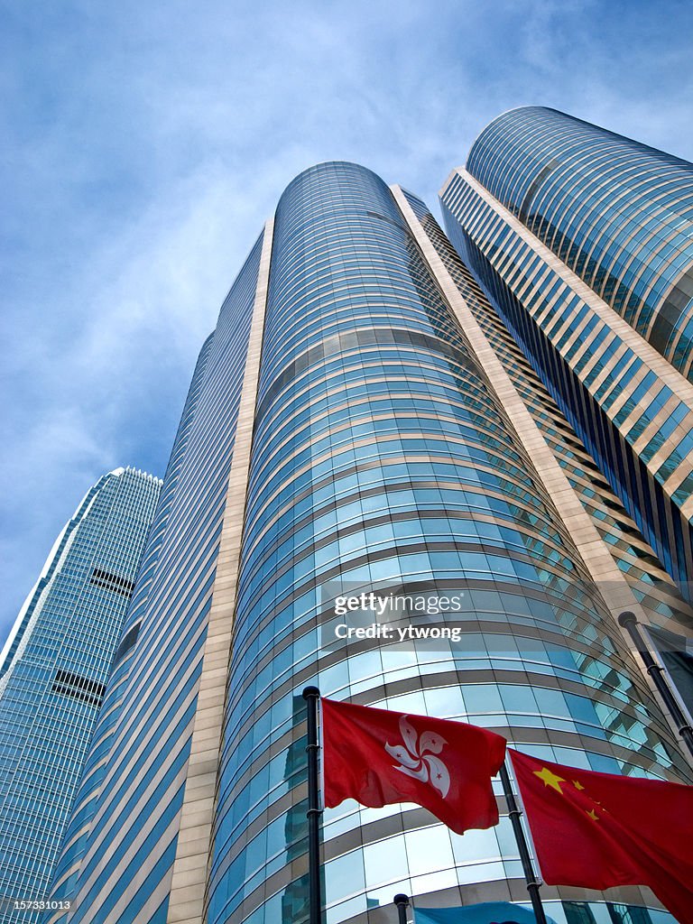 Skyscrapers in Hong Kong financial district behind Chinese and Hong Kong flags